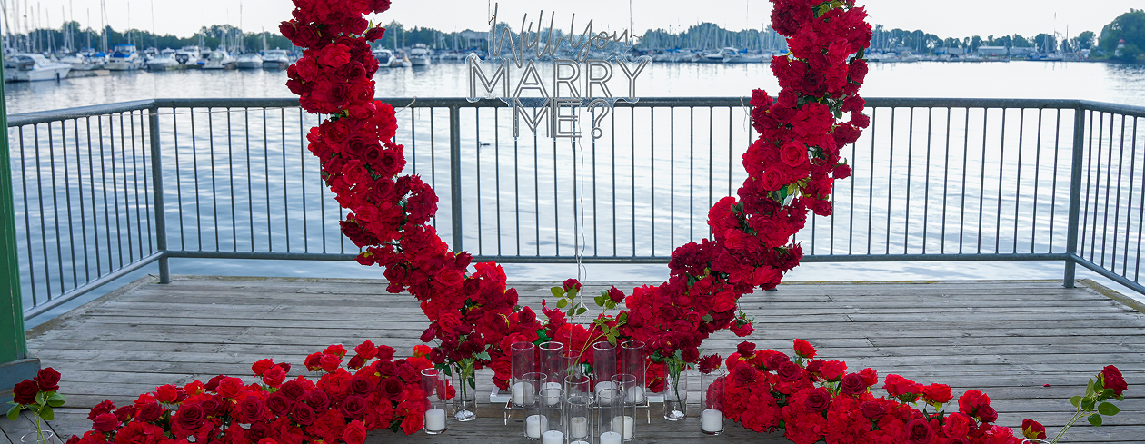 Romantic proposal setting with flowers and water
